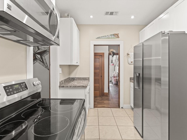 202 S Wood St, Cleburne, TX 76033 - laundry area featuring light tile patterned floors and recessed lighting