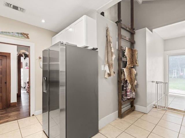 202 S Wood St, Cleburne, TX 76033 - kitchen with stainless steel fridge, light tile patterned floors, white cabinets, baseboards, and recessed lighting