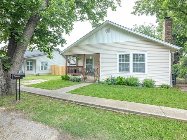 202 S Wood St, Cleburne, TX 76033 - bungalow-style house featuring covered porch, a front lawn, and a chimney