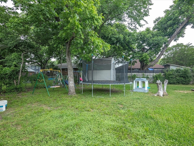 202 S Wood St, Cleburne, TX 76033 - view of yard featuring a trampoline, a playground, and an outdoor structure