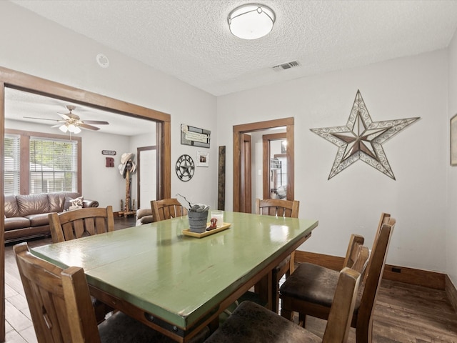 202 S Wood St, Cleburne, TX 76033 - dining area with a textured ceiling, light wood-style floors, and ceiling fan
