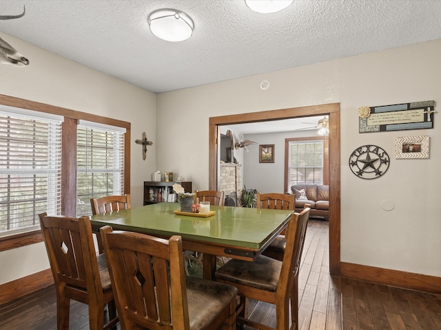 202 S Wood St, Cleburne, TX 76033 - dining room with baseboards, a textured ceiling, hardwood / wood-style flooring, and ceiling fan
