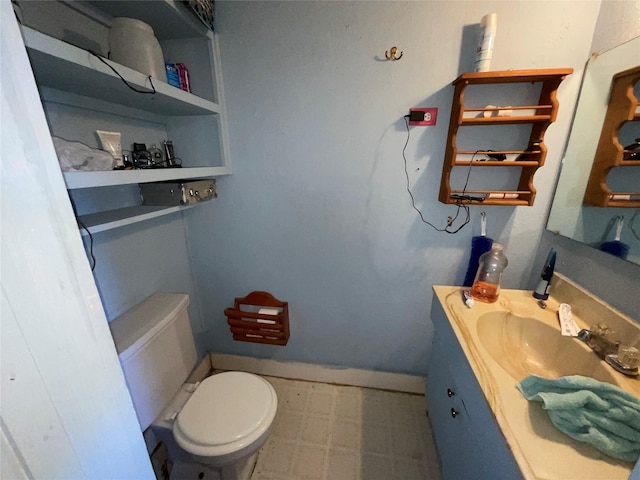 1008 Church St, Sulphur Springs, TX 75482 - half bathroom with tile patterned floors, toilet, vanity, and baseboards