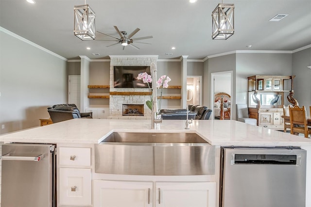 1305 Crown Valley Dr, Weatherford, TX 76087 - kitchen featuring open floor plan, stainless steel dishwasher, a sink, a ceiling fan, and crown molding