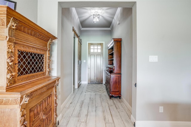 1305 Crown Valley Dr, Weatherford, TX 76087 - hall featuring a barn door, light wood finished floors, baseboards, and ornamental molding