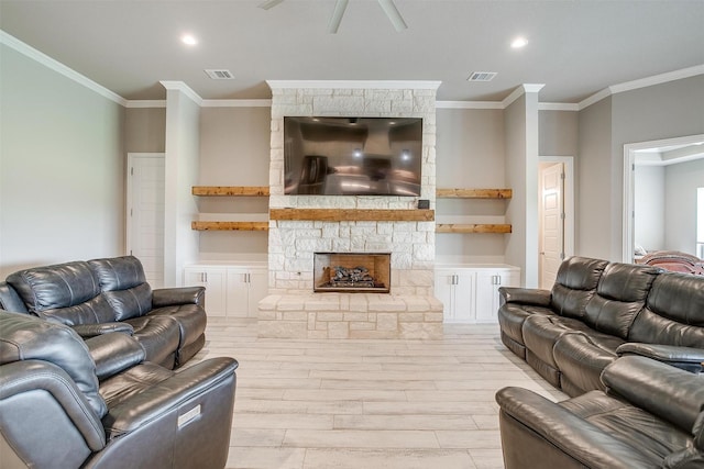 1305 Crown Valley Dr, Weatherford, TX 76087 - living room featuring crown molding, light wood finished floors, ceiling fan, a stone fireplace, and recessed lighting