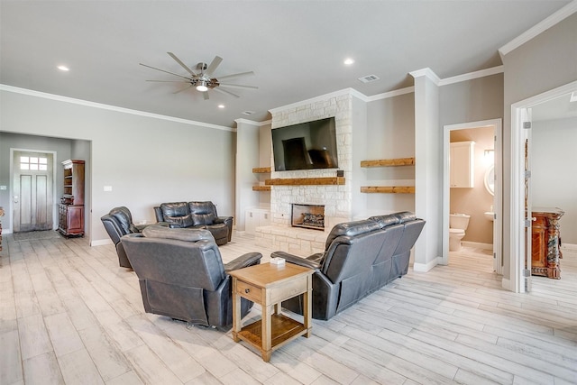 1305 Crown Valley Dr, Weatherford, TX 76087 - living room with a ceiling fan, a stone fireplace, light wood-style flooring, baseboards, and ornamental molding