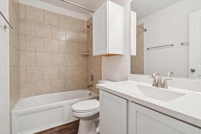 448 Buckeye Ave, Princeton, TX 75407 - bathroom with toilet, vanity, washtub / shower combination, and wood finished floors