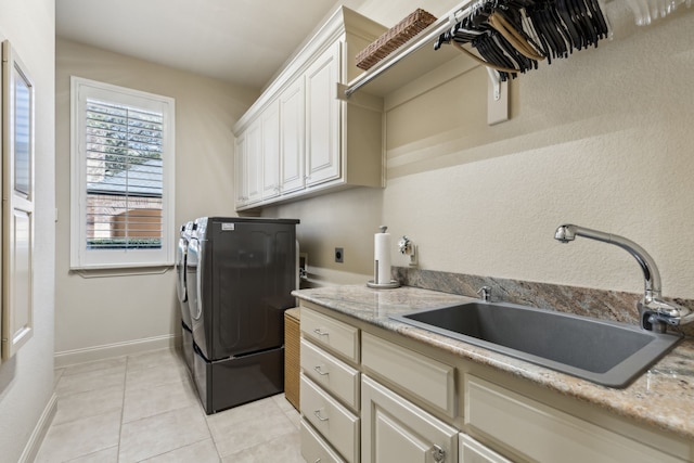 705 Love Henry Ct, Southlake, TX 76092 - washroom with cabinet space, washing machine and clothes dryer, light tile patterned floors, and baseboards