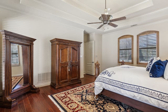 705 Love Henry Ct, Southlake, TX 76092 - bedroom featuring dark wood-style flooring, multiple windows, a tray ceiling, crown molding, and ceiling fan