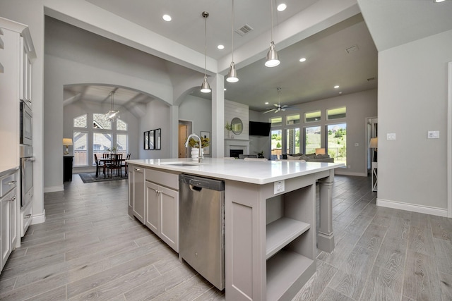 1008 Myers Park Trl, Roanoke, TX 76262 - kitchen featuring a sink, ceiling fan, stainless steel appliances, arched walkways, and open floor plan