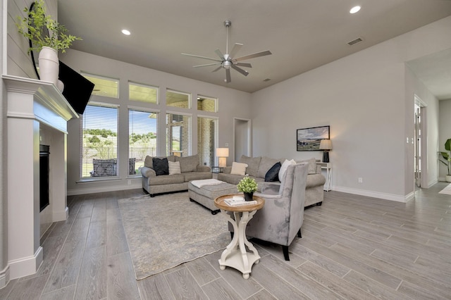 1008 Myers Park Trl, Roanoke, TX 76262 - living room featuring a ceiling fan, baseboards, light wood finished floors, recessed lighting, and a fireplace