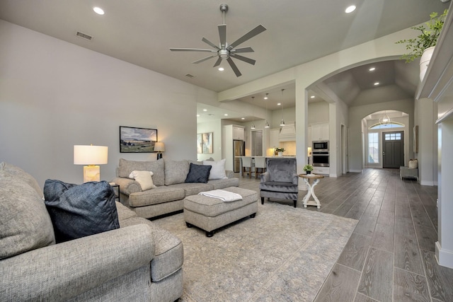 1008 Myers Park Trl, Roanoke, TX 76262 - living area with arched walkways, ceiling fan, recessed lighting, lofted ceiling, and wood finished floors