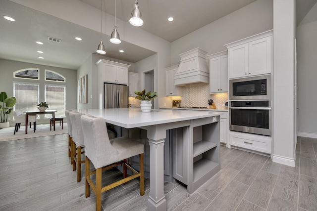 1008 Myers Park Trl, Roanoke, TX 76262 - kitchen with stainless steel appliances, premium range hood, open shelves, light countertops, and decorative backsplash