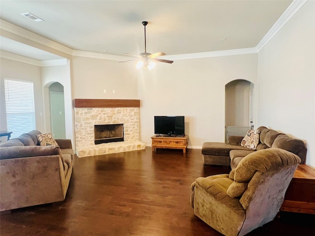 7816 Wheatland Ct, Godley, TX 76044 - living room featuring arched walkways, ornamental molding, a ceiling fan, dark wood finished floors, and a fireplace