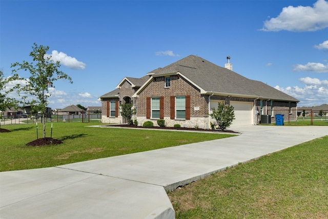 7816 Wheatland Ct, Godley, TX 76044 - view of front facade with central AC unit, concrete driveway, an attached garage, brick siding, and a shingled roof