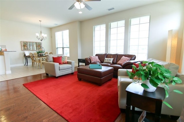 10521 Chaucer Hill Ln, Irving, TX 75063 - living room with a ceiling fan, a chandelier, wood finished floors, and baseboards