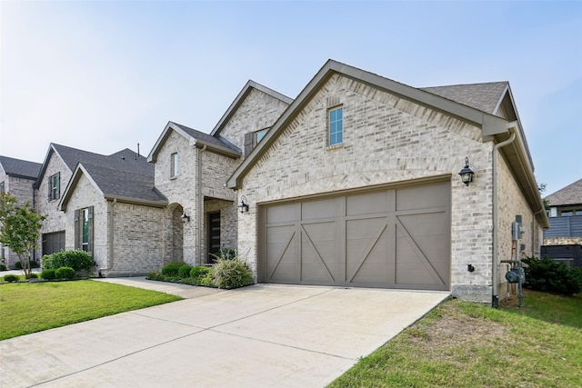 616 Evergreen Rd, Little Elm, TX 76227 - french country inspired facade featuring driveway, an attached garage, a front yard, stone siding, and brick siding