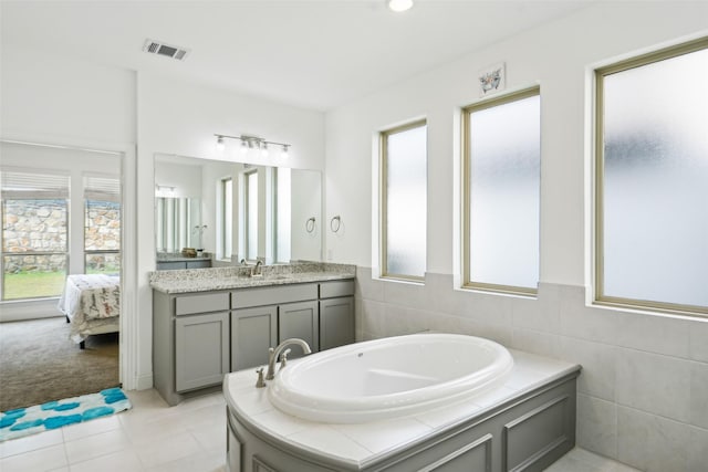 616 Evergreen Rd, Little Elm, TX 76227 - ensuite bathroom featuring a bath, vanity, and tile patterned flooring