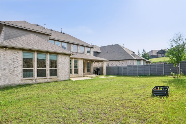 616 Evergreen Rd, Little Elm, TX 76227 - back of house featuring a patio area, a shingled roof, and brick siding