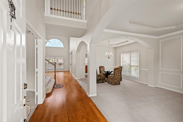 1117 Ruby St, Plano, TX 75094 - foyer with a chandelier, arched walkways, stairway, wood finished floors, and baseboards