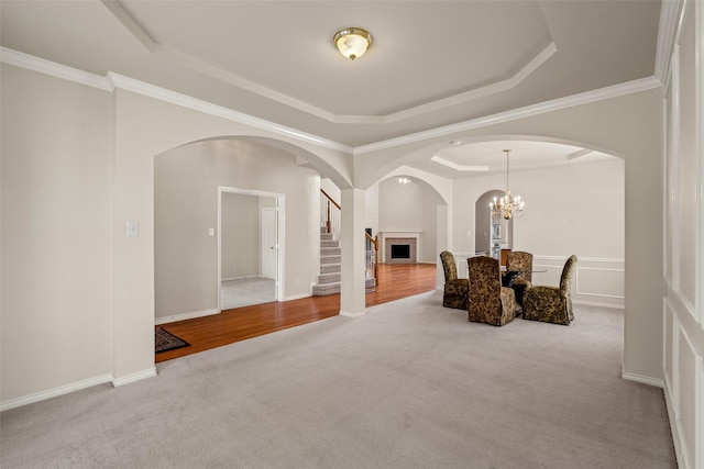 1117 Ruby St, Plano, TX 75094 - sitting room featuring a raised ceiling, carpet flooring, stairway, arched walkways, and a chandelier