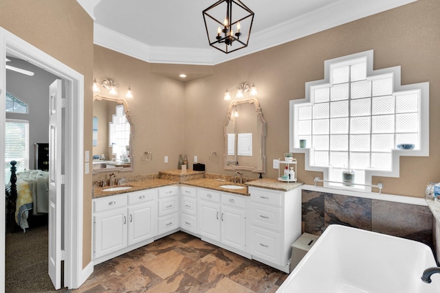 1107 Shoreview Dr, Ennis, TX 75119 - ensuite bathroom with crown molding, a freestanding bath, double vanity, and a chandelier