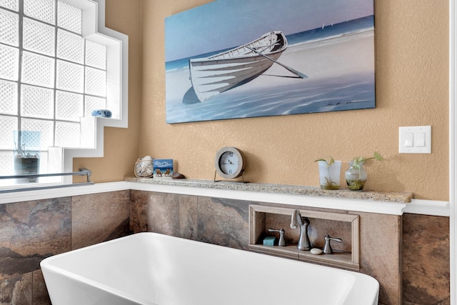 1107 Shoreview Dr, Ennis, TX 75119 - bathroom view of a freestanding bath and a textured wall