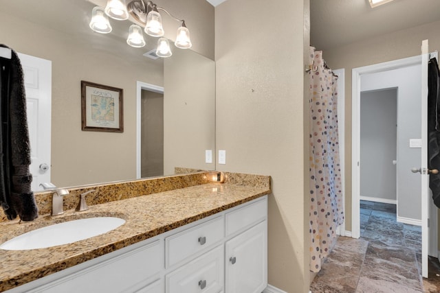 1107 Shoreview Dr, Ennis, TX 75119 - bathroom featuring vanity, stone finish flooring, and baseboards