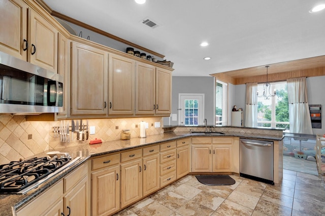 1107 Shoreview Dr, Ennis, TX 75119 - kitchen featuring stainless steel appliances, a sink, plenty of natural light, light brown cabinets, and recessed lighting