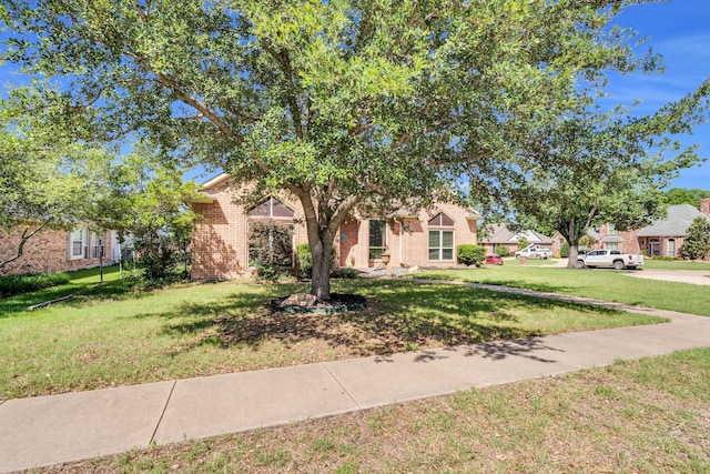 1107 Shoreview Dr, Ennis, TX 75119 - view of property hidden behind natural elements with a front lawn and brick siding