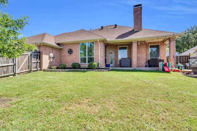1107 Shoreview Dr, Ennis, TX 75119 - rear view of property with brick siding, a chimney, a shingled roof, a gate, and a patio