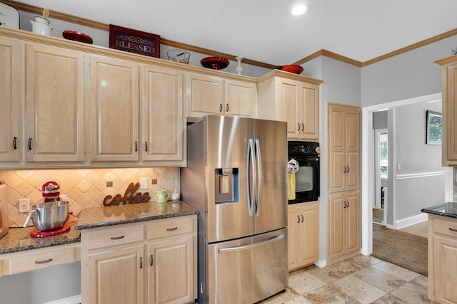 1107 Shoreview Dr, Ennis, TX 75119 - kitchen with stainless steel fridge with ice dispenser, black oven, light brown cabinetry, backsplash, and dark stone countertops