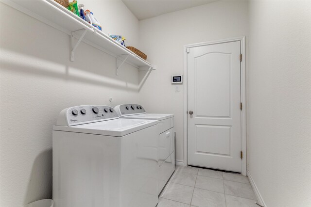 8744 Sleepy Daisy Dr, Fort Worth, TX 76131 - laundry area featuring washer and clothes dryer, light tile patterned flooring, and baseboards