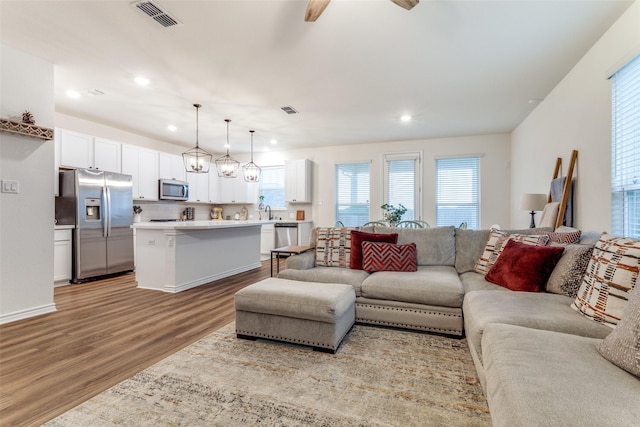 8744 Sleepy Daisy Dr, Fort Worth, TX 76131 - living area with wood finished floors, healthy amount of natural light, recessed lighting, and a ceiling fan