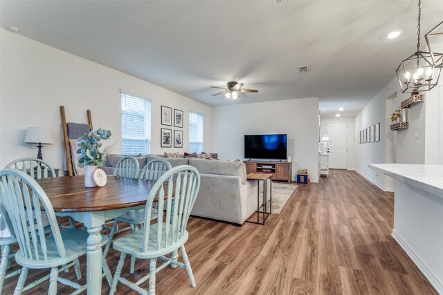 8744 Sleepy Daisy Dr, Fort Worth, TX 76131 - dining area featuring light wood-style floors, a ceiling fan, baseboards, recessed lighting, and a chandelier