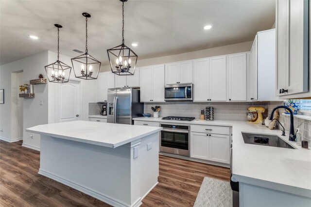 8744 Sleepy Daisy Dr, Fort Worth, TX 76131 - kitchen featuring appliances with stainless steel finishes, a sink, a chandelier, backsplash, and a kitchen island