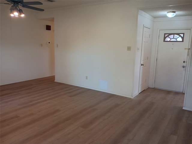 224 Crescent Dr, Hewitt, TX 76643 - entryway with light wood finished floors, ceiling fan, and crown molding