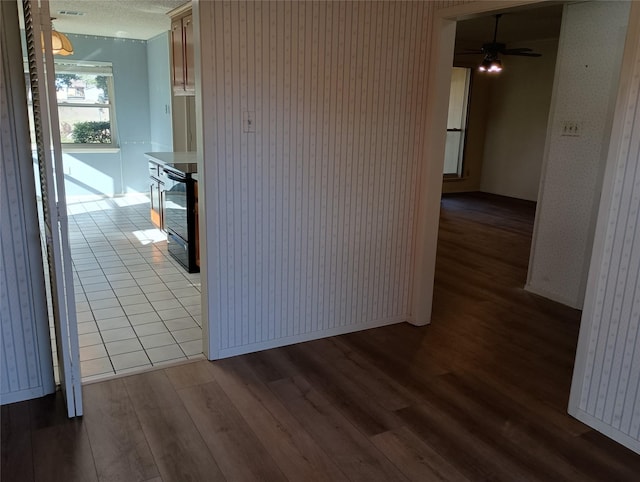 224 Crescent Dr, Hewitt, TX 76643 - hallway with wood finished floors, baseboards, and a textured ceiling
