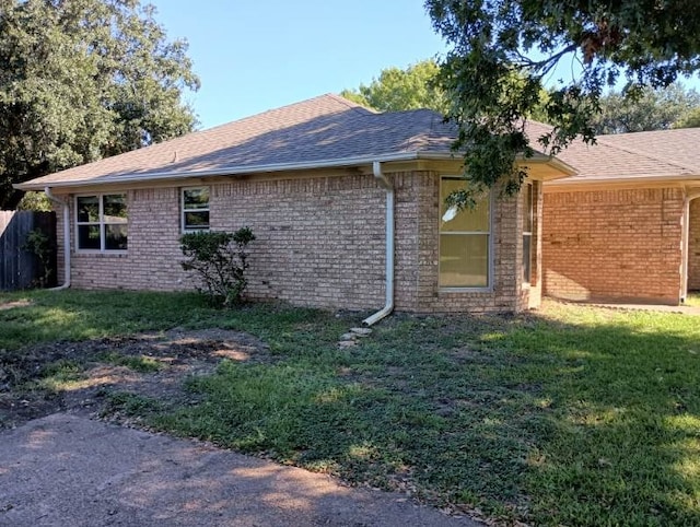 224 Crescent Dr, Hewitt, TX 76643 - view of property exterior with brick siding, a lawn, and a shingled roof
