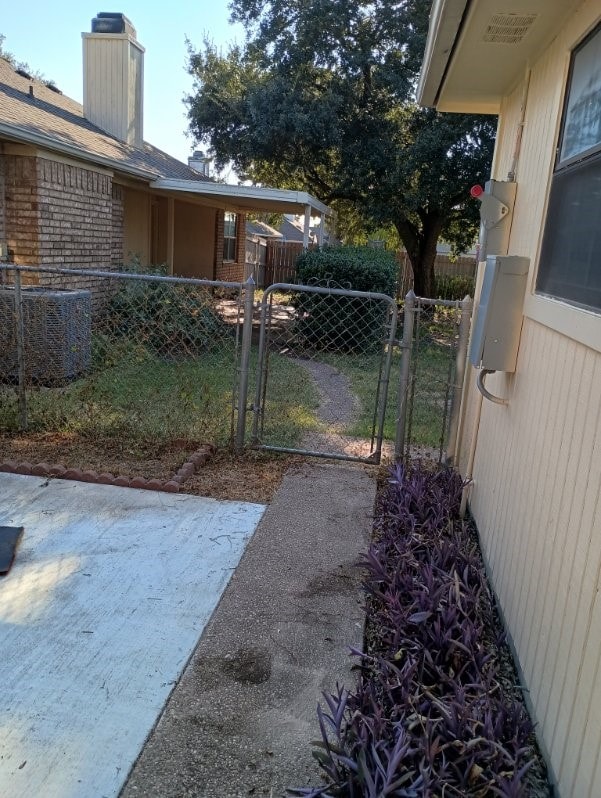 224 Crescent Dr, Hewitt, TX 76643 - view of yard with central air condition unit and a gate