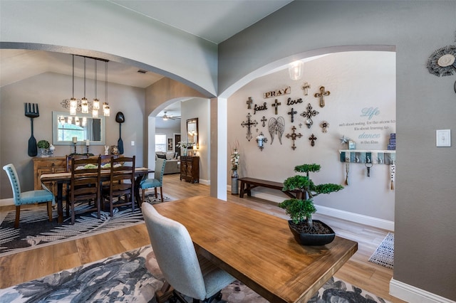1719 Wheatberry Ln, Allen, TX 75002 - dining room with light wood-type flooring, arched walkways, baseboards, and lofted ceiling