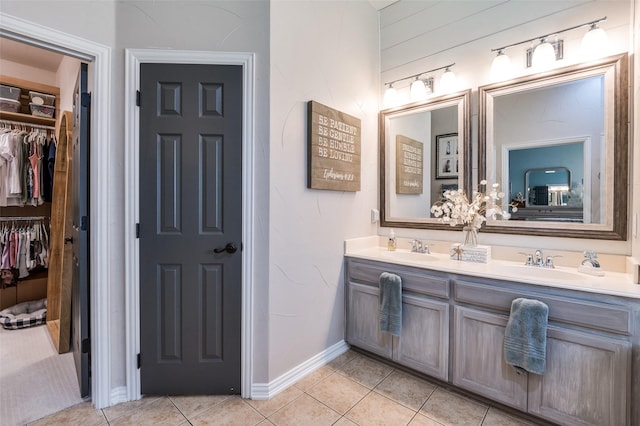 1719 Wheatberry Ln, Allen, TX 75002 - full bathroom with tile patterned flooring, double vanity, a walk in closet, and baseboards