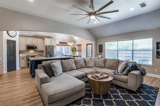 1719 Wheatberry Ln, Allen, TX 75002 - living area with arched walkways, lofted ceiling, a ceiling fan, light wood-type flooring, and recessed lighting