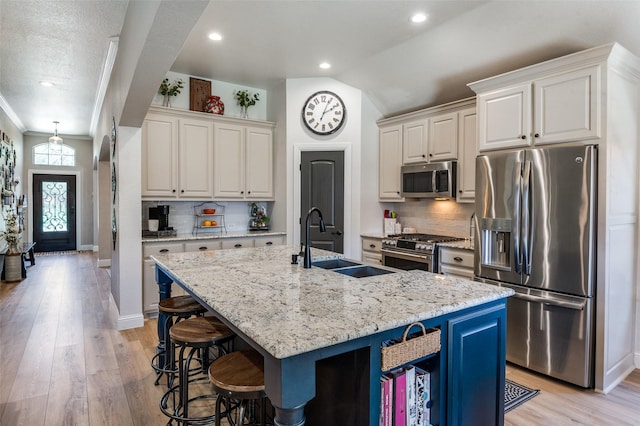 1719 Wheatberry Ln, Allen, TX 75002 - kitchen with appliances with stainless steel finishes, a sink, a kitchen breakfast bar, decorative backsplash, and an island with sink