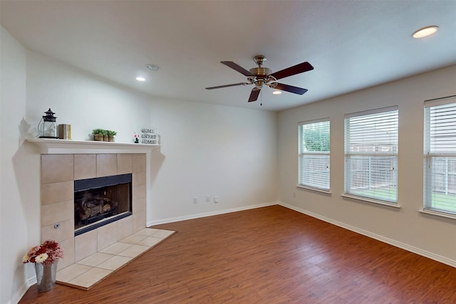 637 Stirrup Bar Dr, Fort Worth, TX 76179 - unfurnished living room featuring wood finished floors, a tiled fireplace, recessed lighting, baseboards, and a ceiling fan