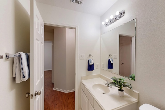 637 Stirrup Bar Dr, Fort Worth, TX 76179 - bathroom featuring wood finished floors, vanity, and toilet