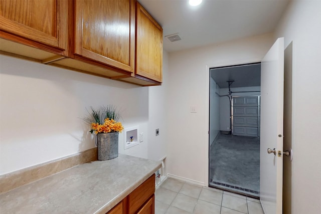 637 Stirrup Bar Dr, Fort Worth, TX 76179 - laundry room featuring electric dryer hookup, cabinet space, washer hookup, light tile patterned floors, and baseboards
