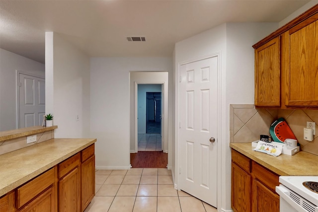 637 Stirrup Bar Dr, Fort Worth, TX 76179 - kitchen featuring brown cabinetry, light tile patterned floors, and light countertops