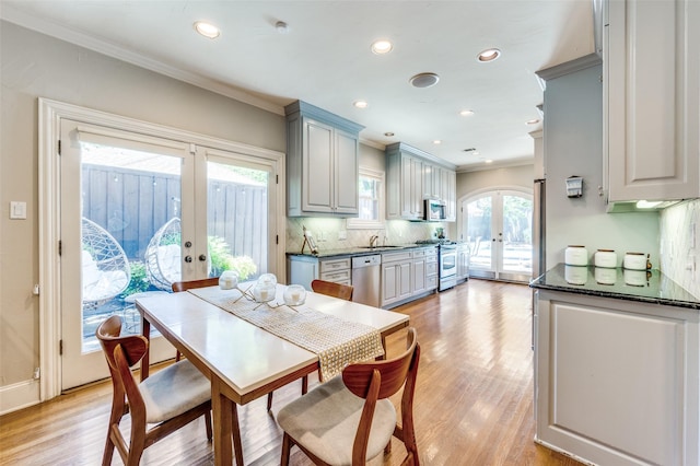 5447 Mccommas Blvd, Dallas, TX 75206 - dining space with french doors, ornamental molding, light wood-type flooring, recessed lighting, and baseboards